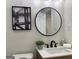 Stylish bathroom with a round mirror, modern fixtures, and a wood vanity at 1751 S Olympian Way, Atlanta, GA 30310