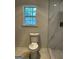 Bright bathroom featuring a toilet, window and shower at 1751 S Olympian Way, Atlanta, GA 30310