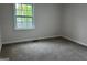 Bright bedroom with neutral paint and carpet, and a double-hung window at 1751 S Olympian Way, Atlanta, GA 30310