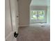 Bright bedroom with plush carpeting and a window overlooking the outdoors at 1751 S Olympian Way, Atlanta, GA 30310