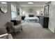 Bright bedroom with two chairs, neutral paint and carpet, and updated lighting at 1751 S Olympian Way, Atlanta, GA 30310