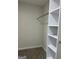 Walk-in closet features custom white shelving and plenty of storage space at 1751 S Olympian Way, Atlanta, GA 30310