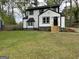 Charming two-story home features a well-maintained lawn and classic black and white exterior paint at 1751 S Olympian Way, Atlanta, GA 30310