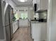 Modern kitchen featuring stainless steel appliances, white cabinetry, and sleek granite countertops at 1751 S Olympian Way, Atlanta, GA 30310