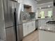 Contemporary kitchen with stainless steel appliances, granite countertops, and stylish tile backsplash at 1751 S Olympian Way, Atlanta, GA 30310