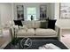 Elegant living area furnished with a plush sofa and adorned with modern paintings at 1751 S Olympian Way, Atlanta, GA 30310