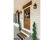 Charming front door with decorative wreath and potted topiaries, creating a welcoming entrance at 105 Honey Creek Rd, Mcdonough, GA 30252
