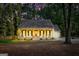Inviting home exterior with warm lighting, a cozy front porch, and a beautiful evening sky at 105 Honey Creek Rd, Mcdonough, GA 30252