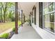 Spacious covered porch with dark wood columns, offering an inviting outdoor living space at 105 Honey Creek Rd, Mcdonough, GA 30252