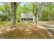 Beautiful home with large trees lining the property and a well maintained yard at 105 Honey Creek Rd, Mcdonough, GA 30252