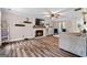 Bright living room features a fireplace, wood-look floors, and stylish decor at 105 Honey Creek Rd, Mcdonough, GA 30252