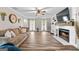 Cozy living room with a fireplace, wood flooring, and plenty of natural light at 105 Honey Creek Rd, Mcdonough, GA 30252