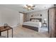 A spacious bedroom with updated ceiling fan, and a sliding barn door to the en suite bathroom at 105 Honey Creek Rd, Mcdonough, GA 30252