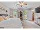Bedroom featuring a ceiling fan, windows, and an armoire for ample storage at 105 Honey Creek Rd, Mcdonough, GA 30252