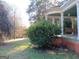 Inviting covered porch with a swing, offering a relaxing outdoor space surrounded by nature at 109 Smith St, Locust Grove, GA 30248