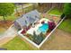 Aerial view of home with a beautiful pool, outdoor fireplace and well-maintained yard at 155 Duncans Mill Dr, Locust Grove, GA 30248