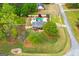 Gorgeous aerial view of the property with a sparkling pool and lush greenery at 155 Duncans Mill Dr, Locust Grove, GA 30248
