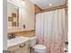 Bathroom featuring a vanity with stylish fixtures, a toilet, and a shower with decorative tile accents at 155 Duncans Mill Dr, Locust Grove, GA 30248