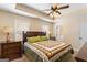 Comfortable bedroom featuring a decorative quilt, ceiling fan, and neutral wall color at 155 Duncans Mill Dr, Locust Grove, GA 30248