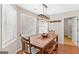 Cozy dining area with a rustic wooden table set beneath a modern industrial-style light fixture at 155 Duncans Mill Dr, Locust Grove, GA 30248