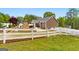 Wide shot of the home's exterior and backyard pool with a stone fireplace at 155 Duncans Mill Dr, Locust Grove, GA 30248