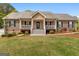 Charming single-story home with a welcoming front porch and well-manicured lawn at 155 Duncans Mill Dr, Locust Grove, GA 30248
