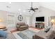 Bright living room with vaulted ceiling, ceiling fan, and hardwood floors at 155 Duncans Mill Dr, Locust Grove, GA 30248