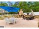 Outdoor patio with stone fireplace and white dining set at 155 Duncans Mill Dr, Locust Grove, GA 30248