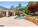 Beautiful backyard pool with a stone surround and seating area at 155 Duncans Mill Dr, Locust Grove, GA 30248