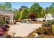 Backyard pool with stone fireplace and landscaped patio is perfect for relaxing or entertaining at 155 Duncans Mill Dr, Locust Grove, GA 30248