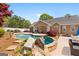 Beautiful backyard pool with a stone surround and outdoor seating area at 155 Duncans Mill Dr, Locust Grove, GA 30248