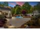 Backyard pool with stone fireplace and landscaped patio is perfect for relaxing or entertaining at 155 Duncans Mill Dr, Locust Grove, GA 30248