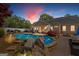 Beautifully landscaped backyard with a sparkling pool, stone accents, and outdoor seating area at 155 Duncans Mill Dr, Locust Grove, GA 30248