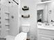 Clean and modern bathroom featuring a shower, toilet, vanity, and white tile at 2800 Chelsey Trl, Jonesboro, GA 30236