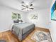 Comfortable bedroom with neutral walls, ceiling fan, decorative rug and vinyl wood floors at 2800 Chelsey Trl, Jonesboro, GA 30236
