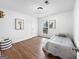 Cozy bedroom with hardwood floors, natural light, and whimsical artwork at 2800 Chelsey Trl, Jonesboro, GA 30236