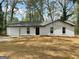 Charming single-story home with a white brick facade, attached garage, and a freshly mulched front yard at 2800 Chelsey Trl, Jonesboro, GA 30236