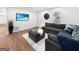 Cozy living room featuring a large sectional sofa, decorative rug, and wall-mounted TV at 2800 Chelsey Trl, Jonesboro, GA 30236