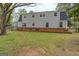 View of the back of the house, showcasing the second-story windows and porch area at 6140 Ginn Se St, Covington, GA 30014