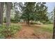 Landscaped backyard showing the house and some flowering plants at 6140 Ginn Se St, Covington, GA 30014
