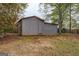 Backyard shed featuring a door and ample storage at 6140 Ginn Se St, Covington, GA 30014