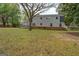 Backyard view of the house and some green lawn at 6140 Ginn Se St, Covington, GA 30014