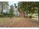 Backyard view of the house with a brick chimney and foundation and green landscaping at 6140 Ginn Se St, Covington, GA 30014