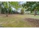 Large, grassy backyard with mature trees and privacy fence at 6140 Ginn Se St, Covington, GA 30014