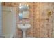 Bathroom featuring a pedestal sink and patterned wallpaper at 6140 Ginn Se St, Covington, GA 30014
