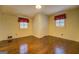 Spacious bedroom featuring hardwood floors and two windows, offering plenty of natural light at 6140 Ginn Se St, Covington, GA 30014