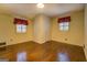 Bright bedroom featuring hardwood floors, two windows, and ample closet space at 6140 Ginn Se St, Covington, GA 30014