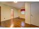 Bedroom featuring hardwood floors, light walls, and closet space at 6140 Ginn Se St, Covington, GA 30014