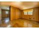 Bright bedroom featuring hardwood floors, wood paneling, and natural light from a window at 6140 Ginn Se St, Covington, GA 30014