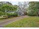 A home's exterior featuring a sunroom, fenced yard, long driveway and green lawn at 6140 Ginn Se St, Covington, GA 30014